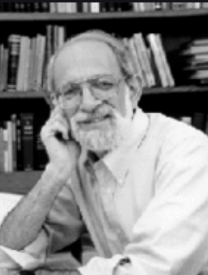 Photo Of Jeffrey H. Tigay Sitting In Front Of A Bookshelf 